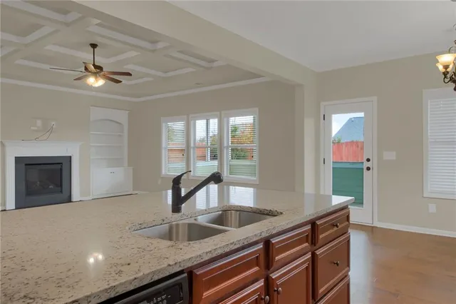 a kitchen with granite countertop a sink and a window