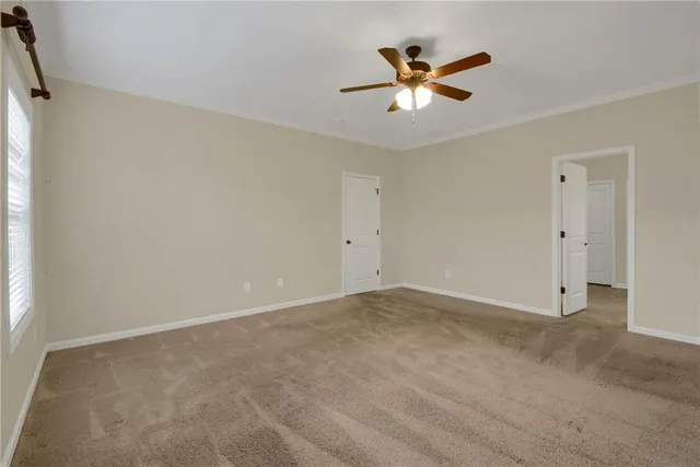 an empty room with closet and windows