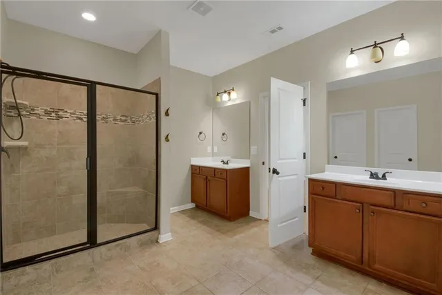 a bathroom with double vanity sink and mirror