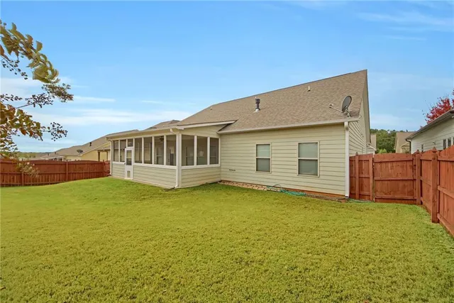 a view of a house with a backyard