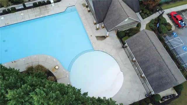 an aerial view of a house with swimming pool and porch