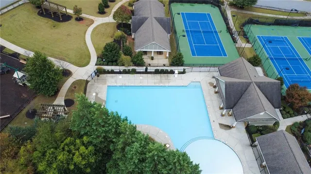 an aerial view of pool patio outdoor seating and outdoor kitchen view