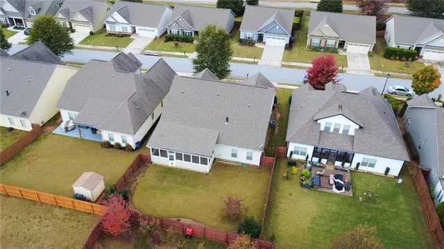 a view of a house with pool and a yard