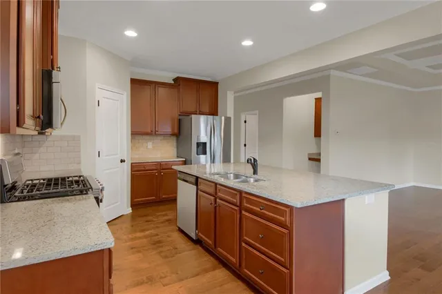 a kitchen with a sink stove and refrigerator