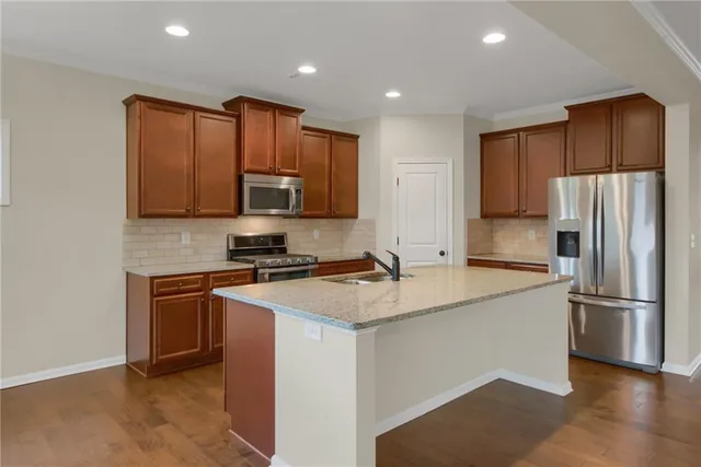 a kitchen with wooden cabinets and stainless steel appliances