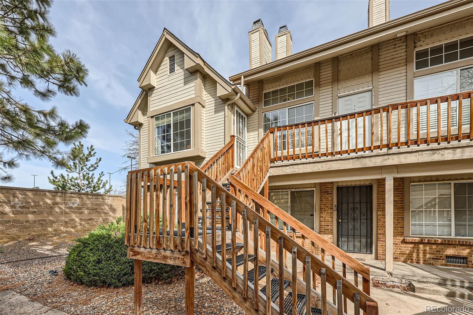 165 South Sable Boulevard, Unit R21 Aurora, CO 80012 - Photo 1 of 28 a front view of a house with wooden stairs