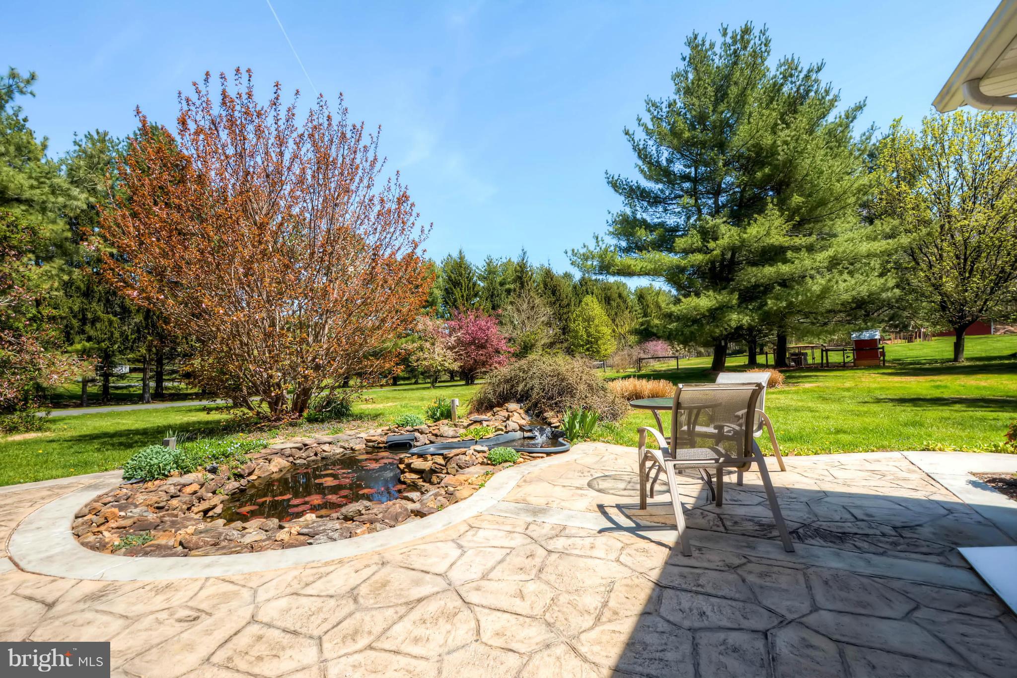 3849 Bay Road Street, MD 21154 - Photo 23 of 30 Stamped Concrete Patio Overlooking Fish Pond