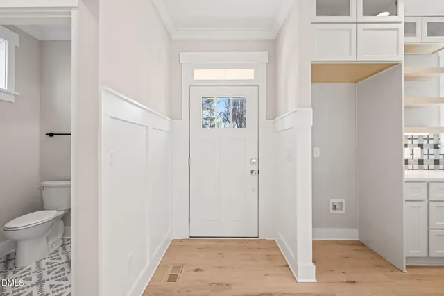 a large white kitchen with kitchen island a sink appliances and a counter top space