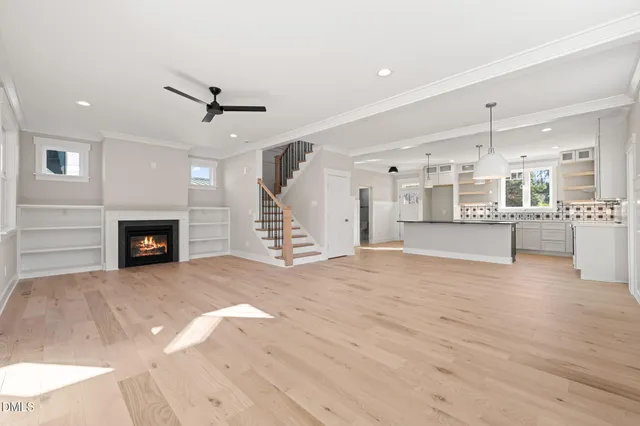 an empty room with wooden floor and fireplace