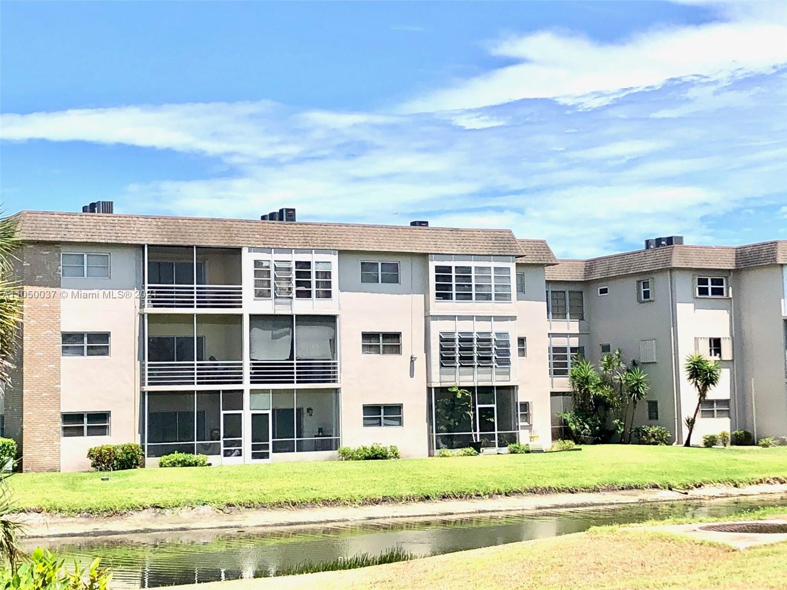 Arrowhead Davie, FL 33324 - Photo 20 of 21 a front view of a building with a garden and plants