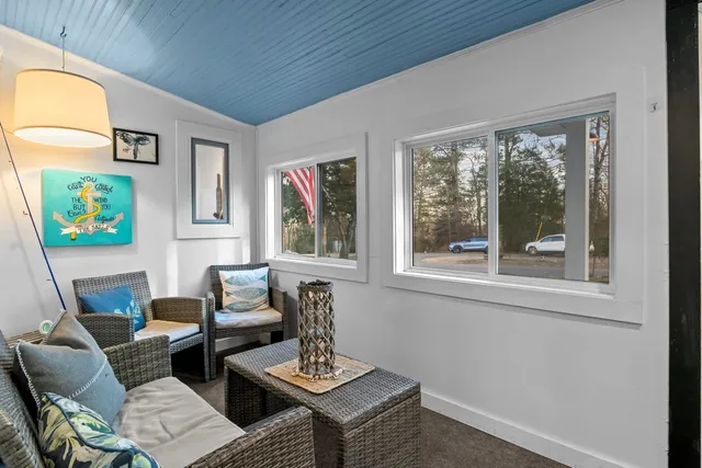 a kitchen with stainless steel appliances granite countertop a stove refrigerator a dining table and chairs with the wooden floor