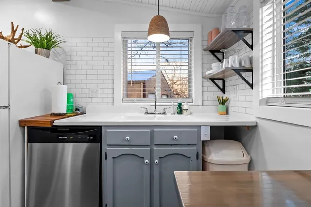 a bedroom with two beds and painting on the wall