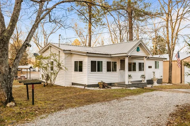 a sign board with buildings in the background