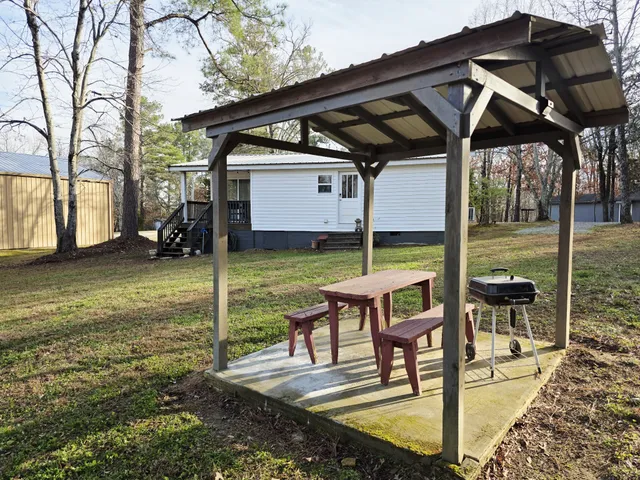 a front view of a house with a yard table and chairs