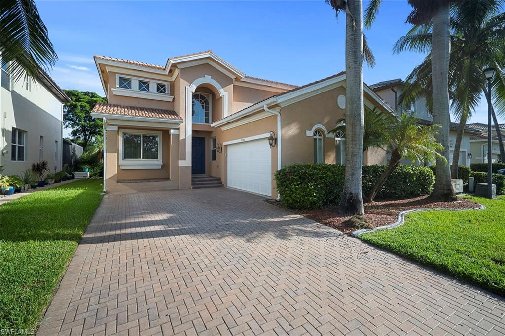8286 Sumner Avenue, Unit 1 Fort Myers, FL 33908 - Photo 1 of 13 Mediterranean / spanish home with stucco siding, decorative driveway, a front yard, and a tiled roof