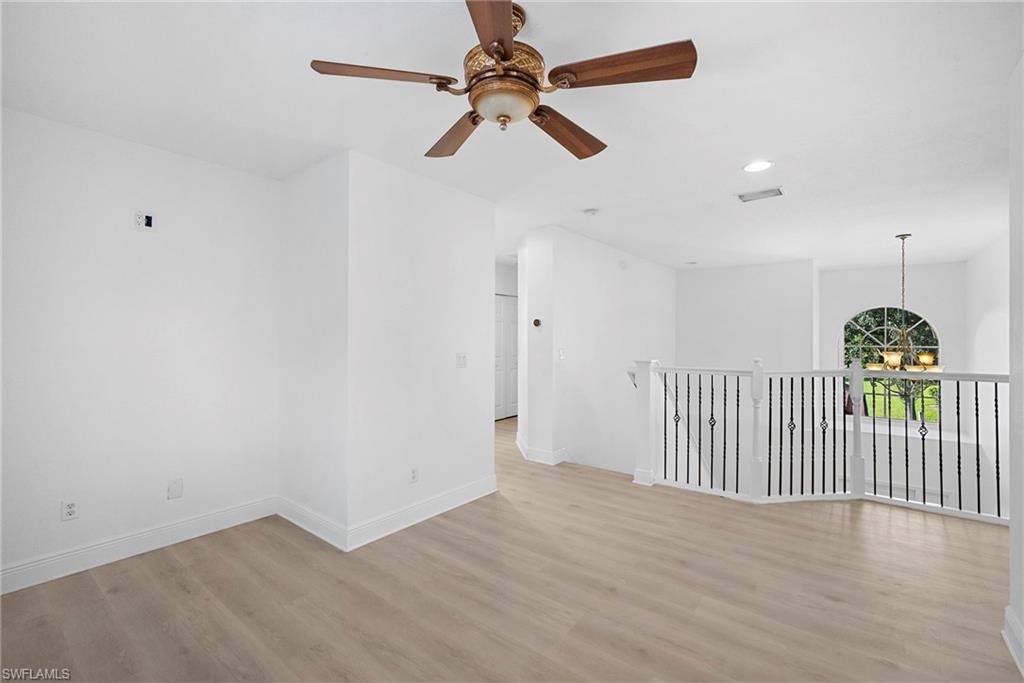 8286 Sumner Avenue, Unit 1 Fort Myers, FL 33908 - Photo 11 of 13 Stairs landing featuring recessed lighting, a chandelier, light wood-style floors, and a ceiling fan