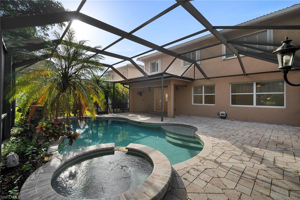 8286 Sumner Avenue, Unit 1 Fort Myers, FL 33908 - Photo 6 of 13 View of swimming pool with a sunroom, a pool with connected hot tub, a patio area, and a lanai