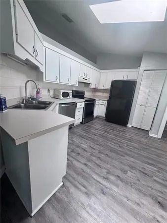 a kitchen with wooden cabinets and white appliances