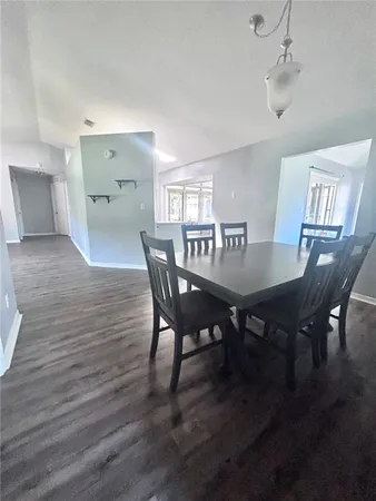 a view of a dining room with furniture and wooden floor