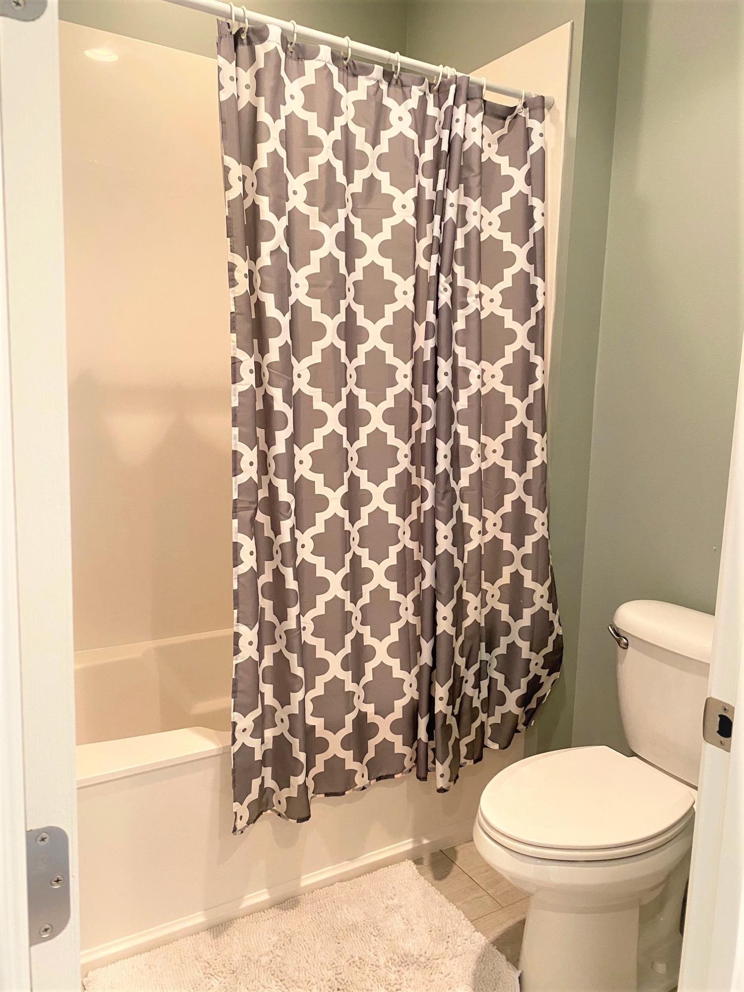 64 Hatton Court Santa Rosa Beach, FL 32459 - Photo 20 of 37 a white toilet sitting next to a shower curtain