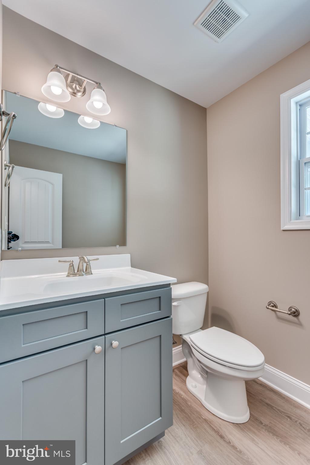 1 Libby's Ridge Road Berkeley Springs, WV 25411 - Photo 15 of 31 a bathroom with a toilet a sink and mirror