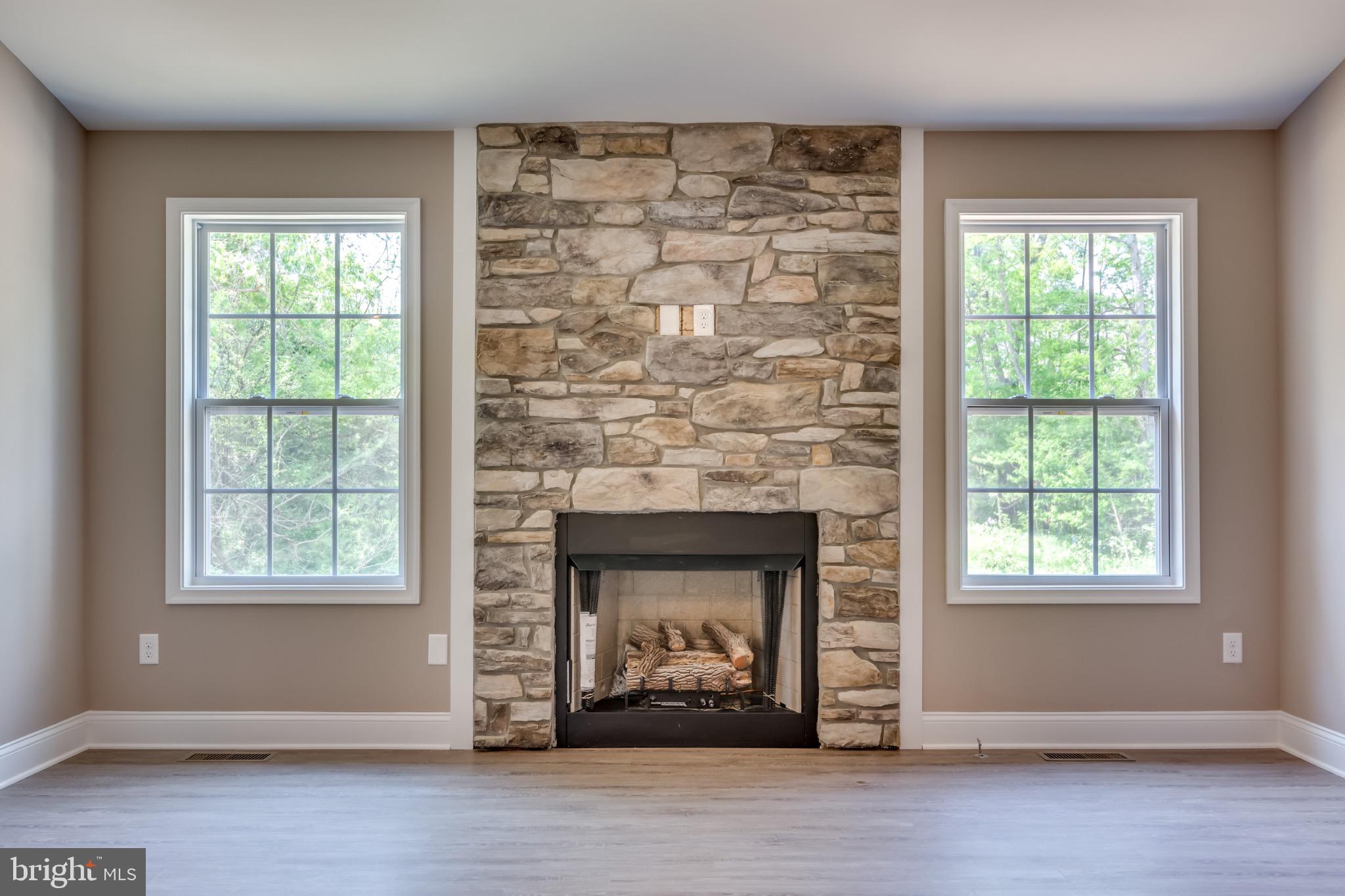 1 Libby's Ridge Road Berkeley Springs, WV 25411 - Photo 4 of 31 an empty room with windows and a fireplace
