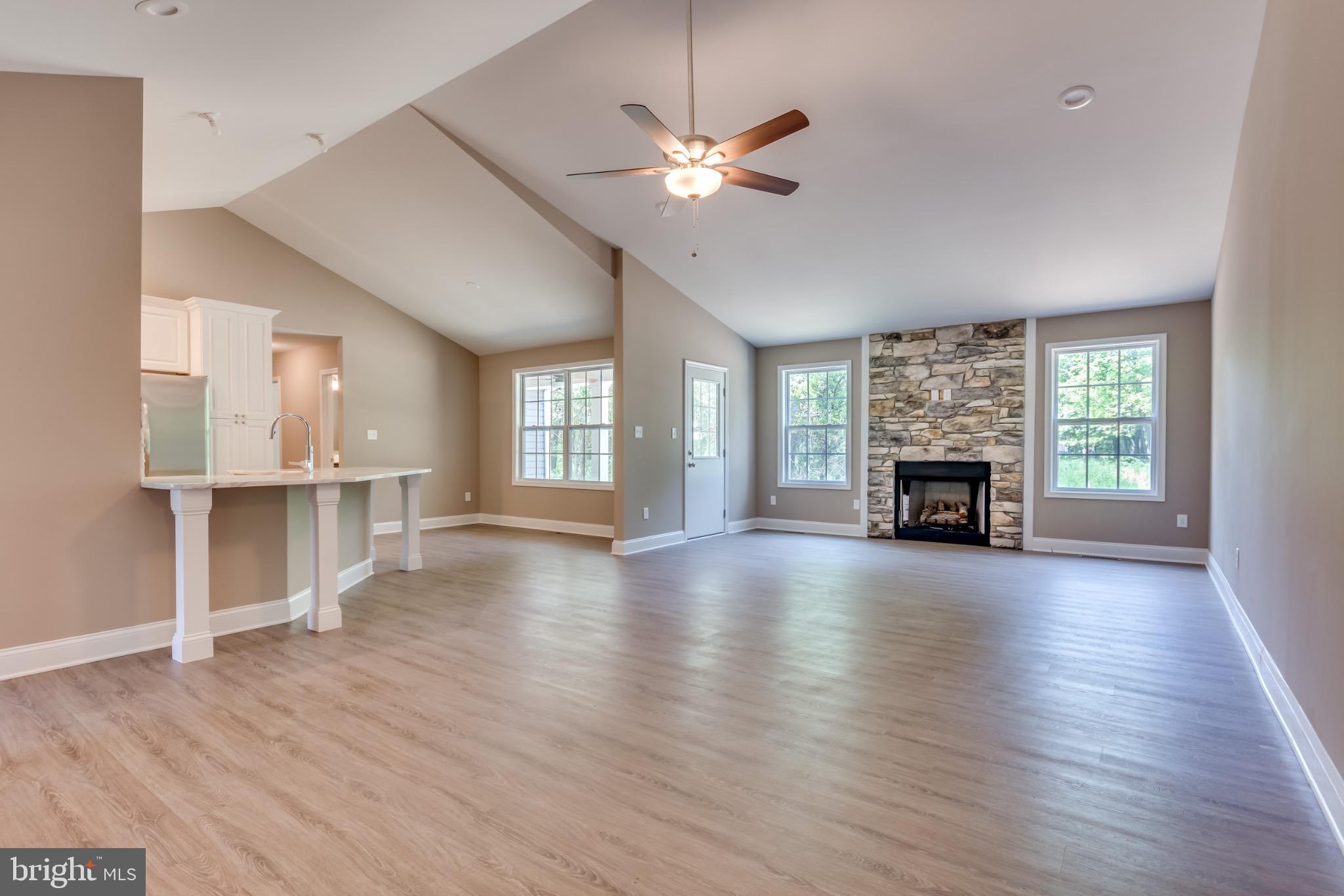 1 Libby's Ridge Road Berkeley Springs, WV 25411 - Photo 5 of 31 a view of empty room with wooden floor and fireplace