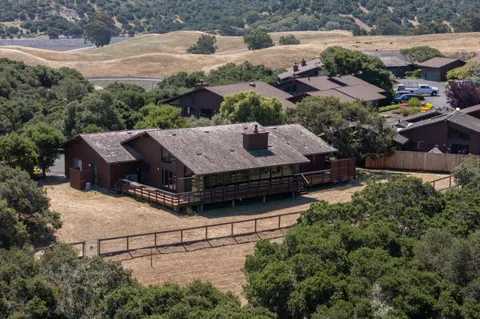 an aerial view of a house with a yard basket ball court and outdoor seating