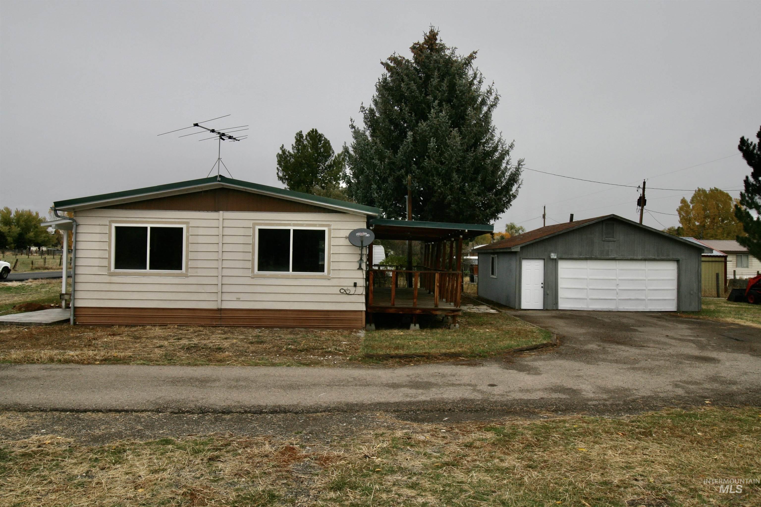 500 Somerville Street Jordan Valley, OR 97910 - Photo 12 of 35 View of front of property featuring an outdoor structure, a detached garage, and a wooden deck