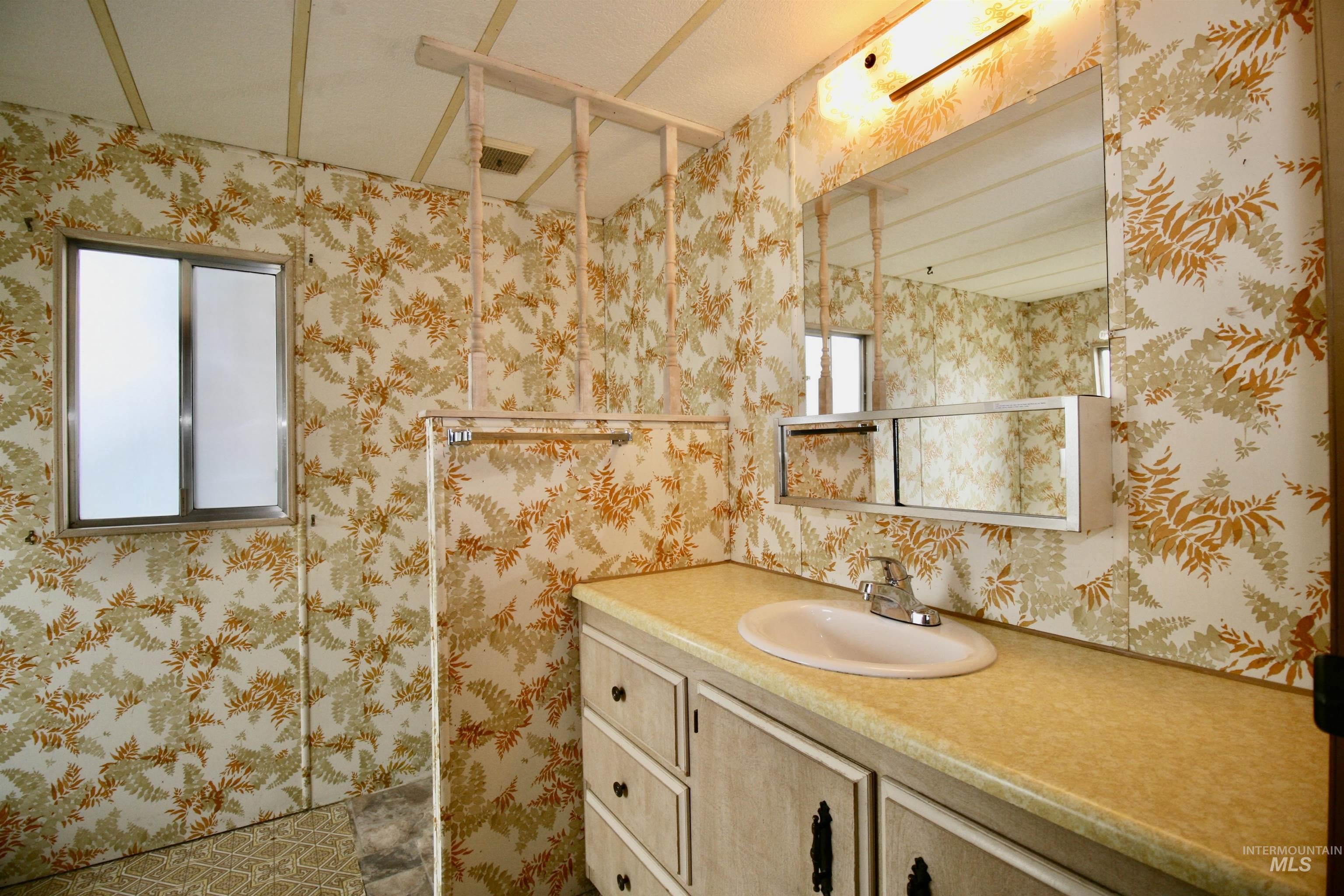500 Somerville Street Jordan Valley, OR 97910 - Photo 19 of 35 Bathroom featuring wallpapered walls and vanity