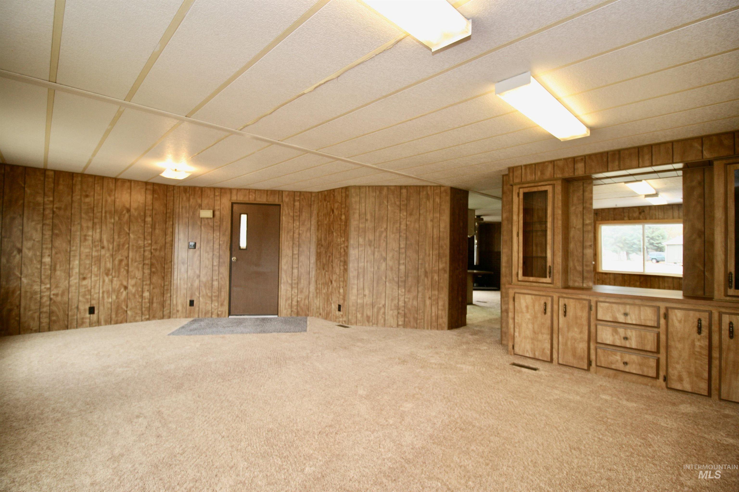 500 Somerville Street Jordan Valley, OR 97910 - Photo 29 of 35 Carpeted empty room with wood walls