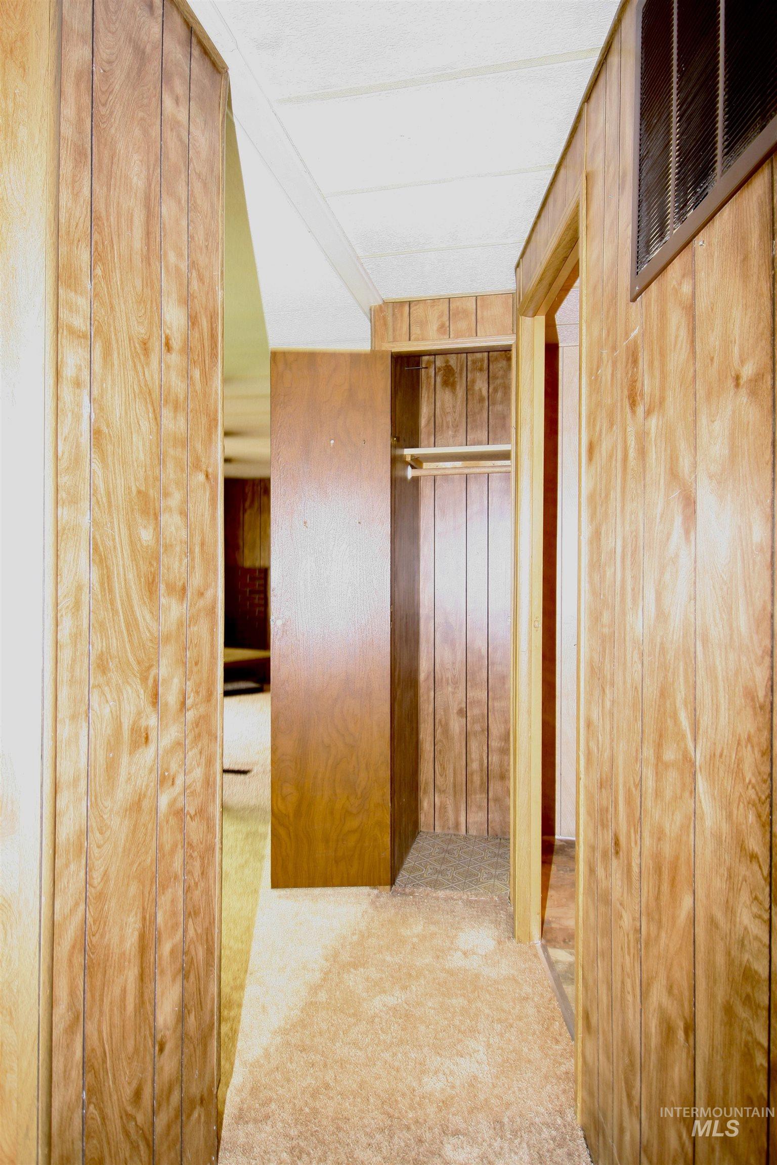 500 Somerville Street Jordan Valley, OR 97910 - Photo 30 of 35 Corridor with light colored carpet and wood walls