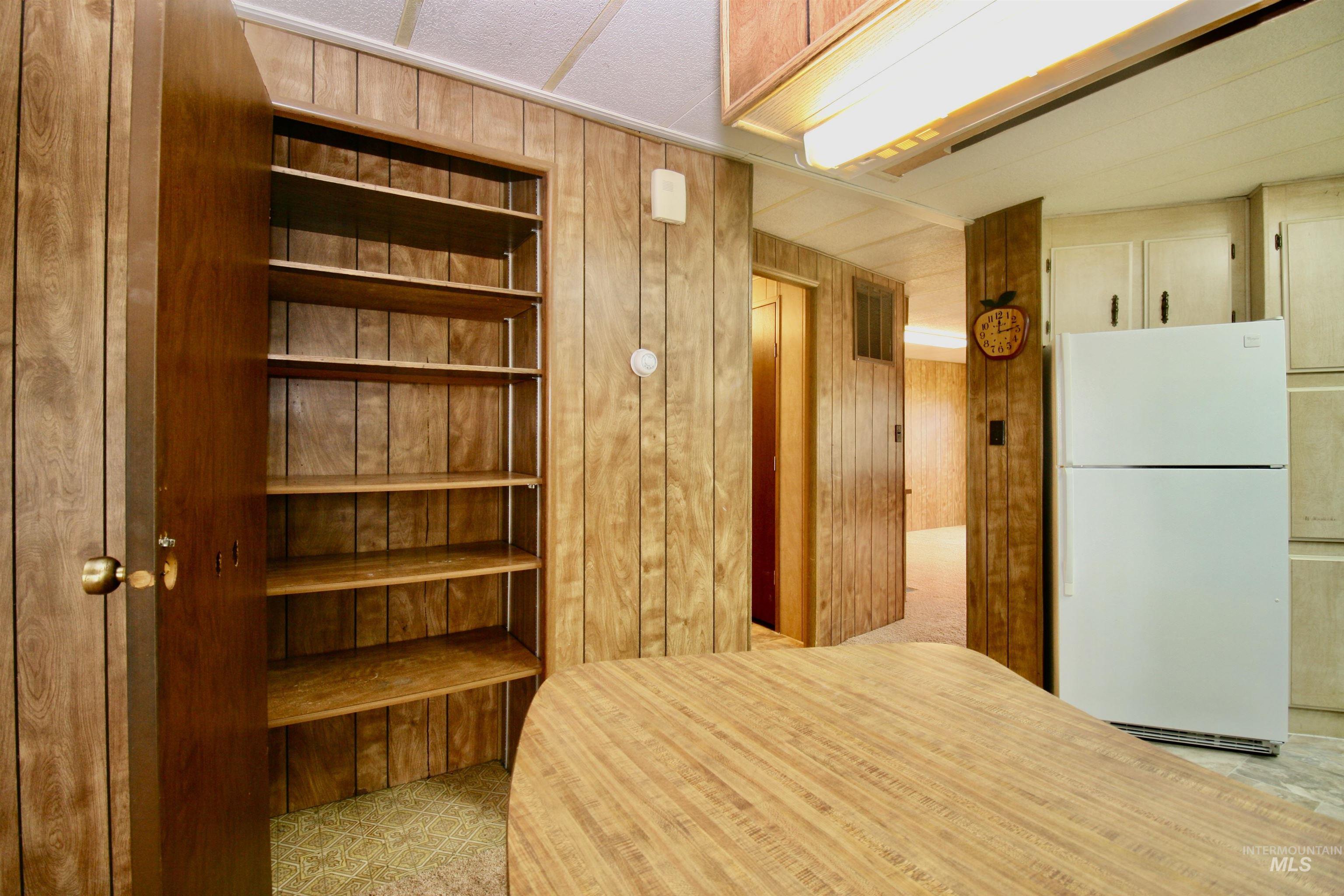 500 Somerville Street Jordan Valley, OR 97910 - Photo 33 of 35 Kitchen featuring wooden walls and freestanding refrigerator