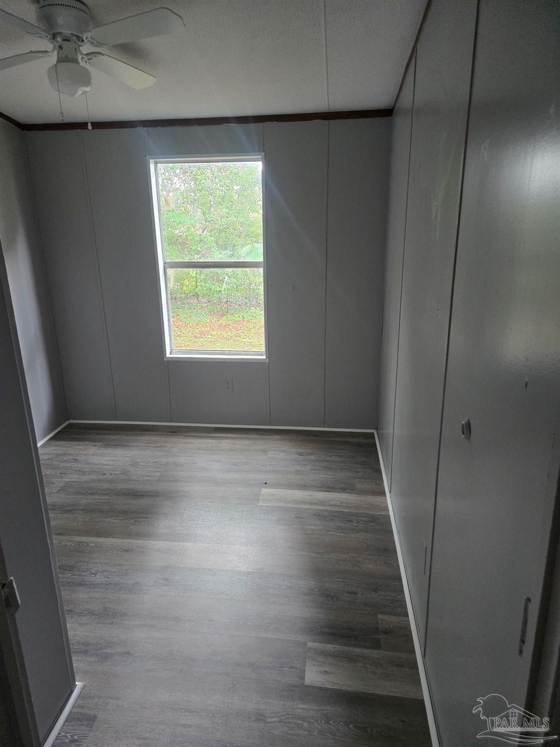 5675 Saufley Field Road, Unit 9 Pensacola, FL 32526 - Photo 1 of 15 an empty room with wooden floor and windows