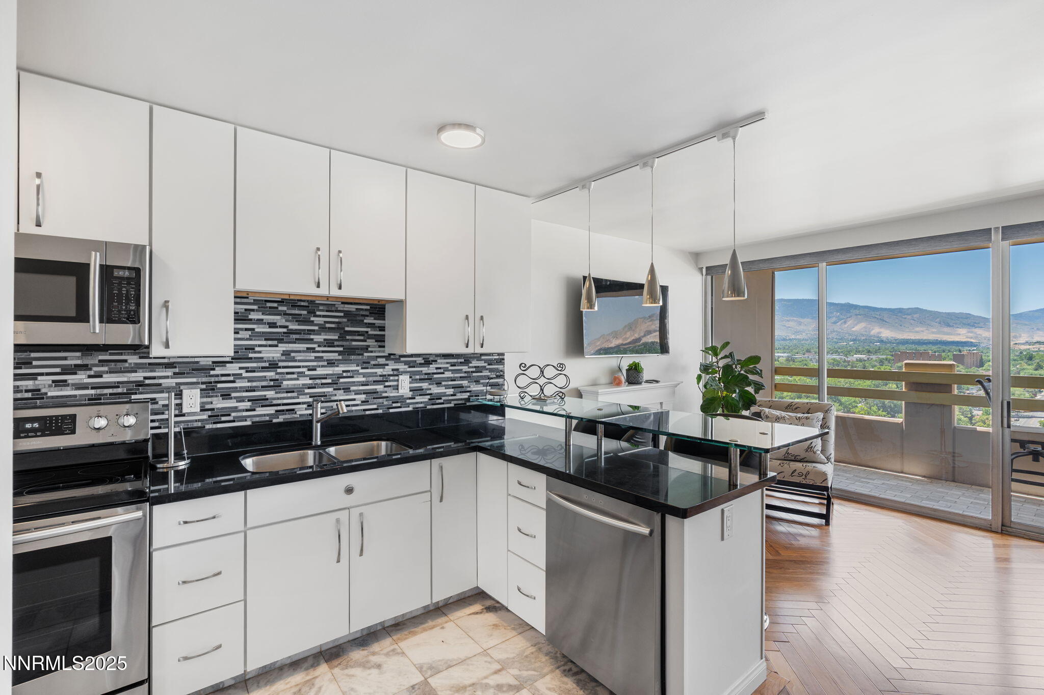 a kitchen with stainless steel appliances kitchen island granite countertop a sink a stove and white cabinets