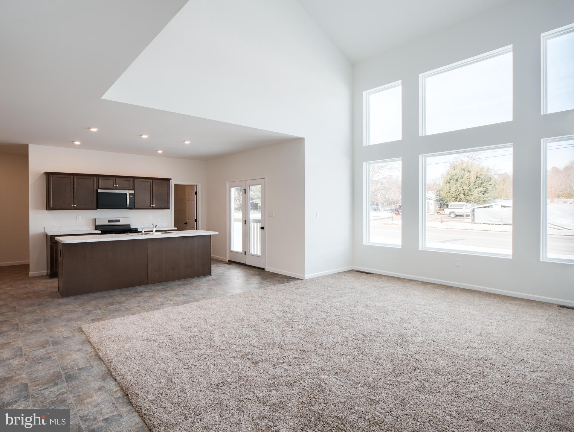 415 Little Walnut Court Windsor, PA 17366 - Photo 22 of 53 a view of kitchen with kitchen island a sink wooden floor and refrigerator