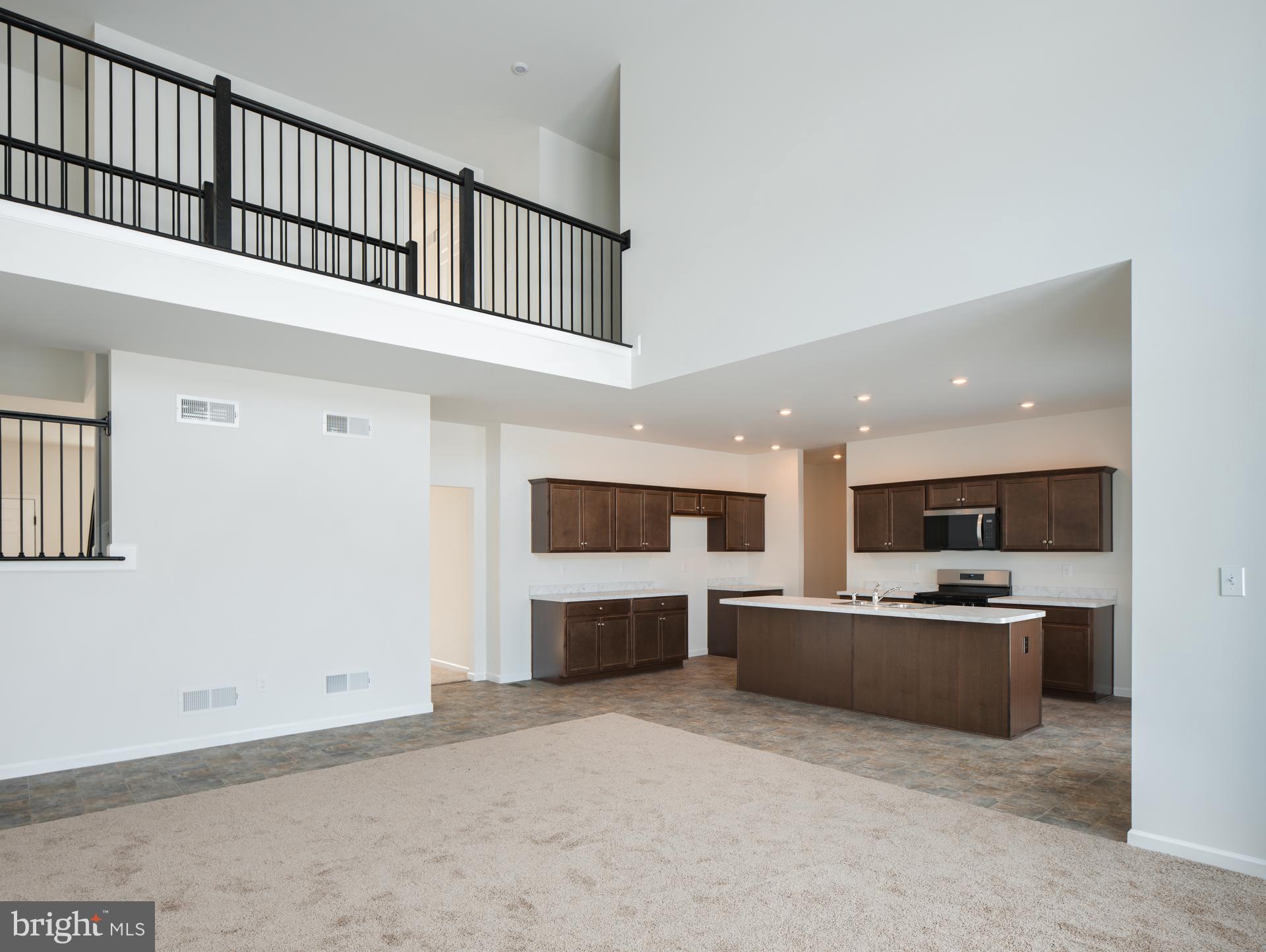 415 Little Walnut Court Windsor, PA 17366 - Photo 25 of 53 a living room with stainless steel appliances kitchen island a sink a refrigerator and a fireplace