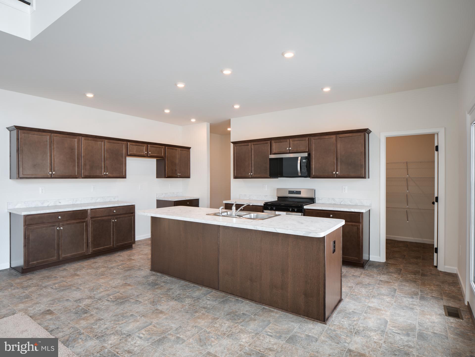 415 Little Walnut Court Windsor, PA 17366 - Photo 26 of 53 a large white kitchen with stainless steel appliances granite countertop a sink and white cabinets