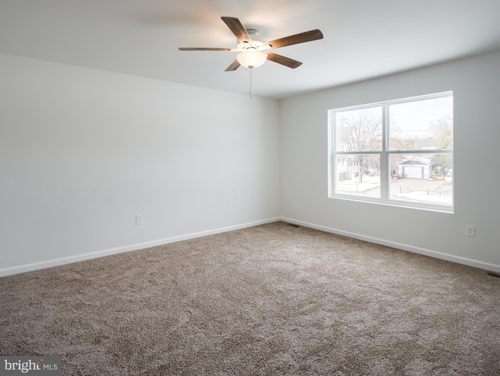 415 Little Walnut Court Windsor, PA 17366 - Photo 7 of 53 an empty room with a window and a fan