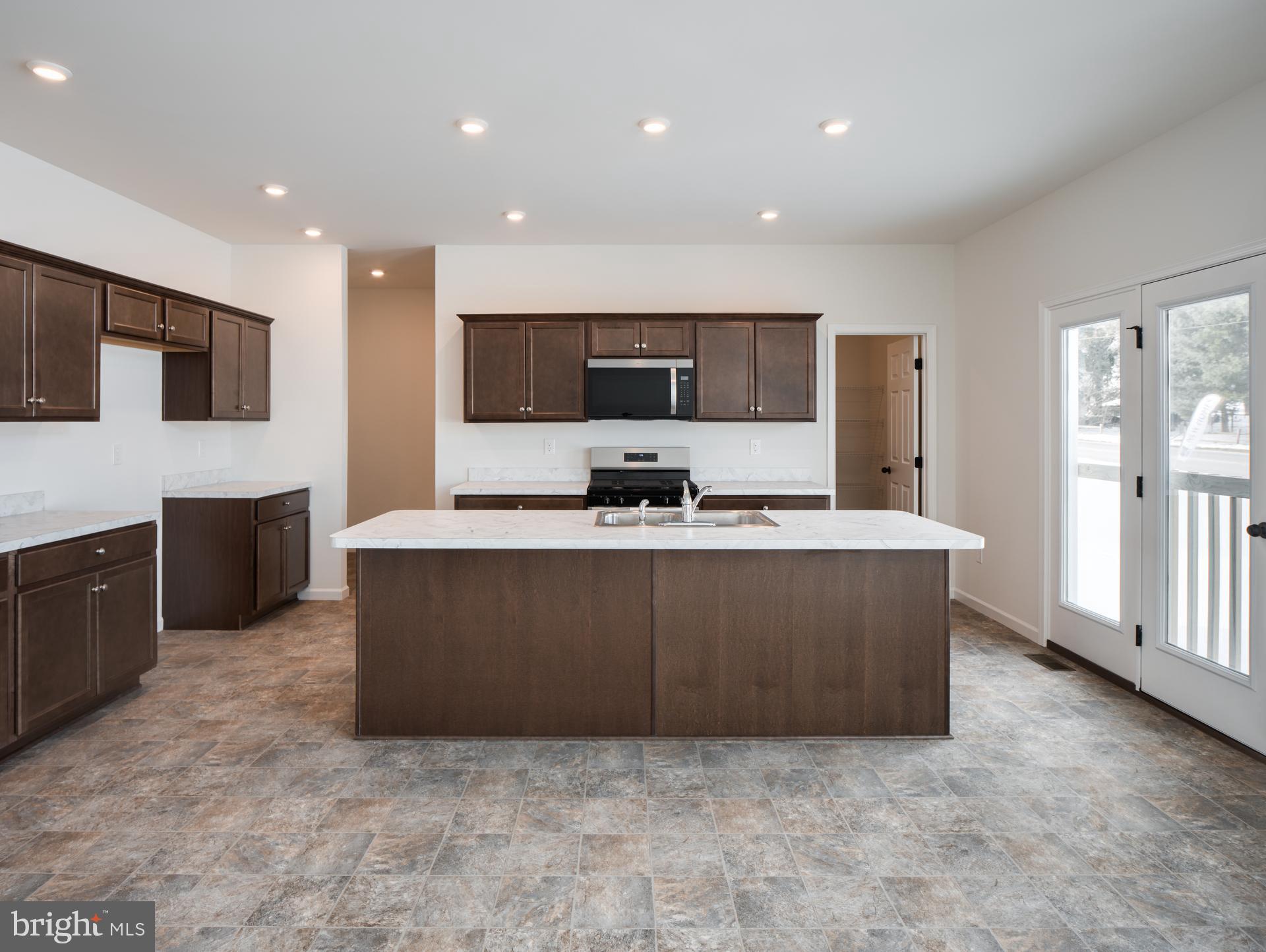415 Little Walnut Court Windsor, PA 17366 - Photo 9 of 53 a living room with stainless steel appliances kitchen island granite countertop a couch and a view of kitchen