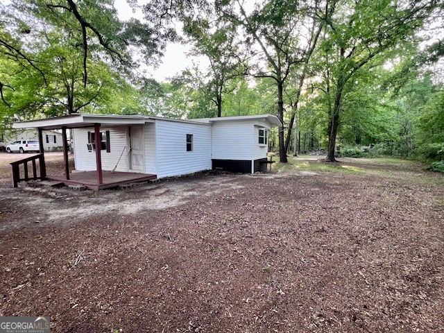 3195 Henderson Grove Road Sandersville, GA 31082 - Photo 22 of 50 a view of a backyard with large trees and wooden fence