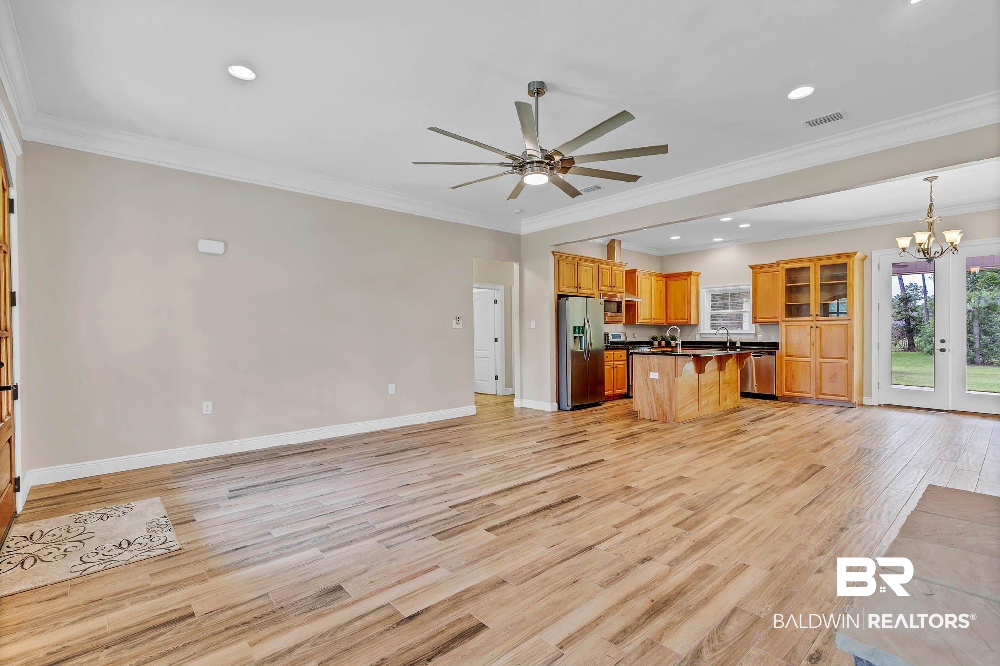 8145 Bay View Drive Foley, AL 36535 - Photo 80 of 81 Kitchen featuring stainless steel appliances, open floor plan, a breakfast bar, ceiling fan, and light wood-style flooring