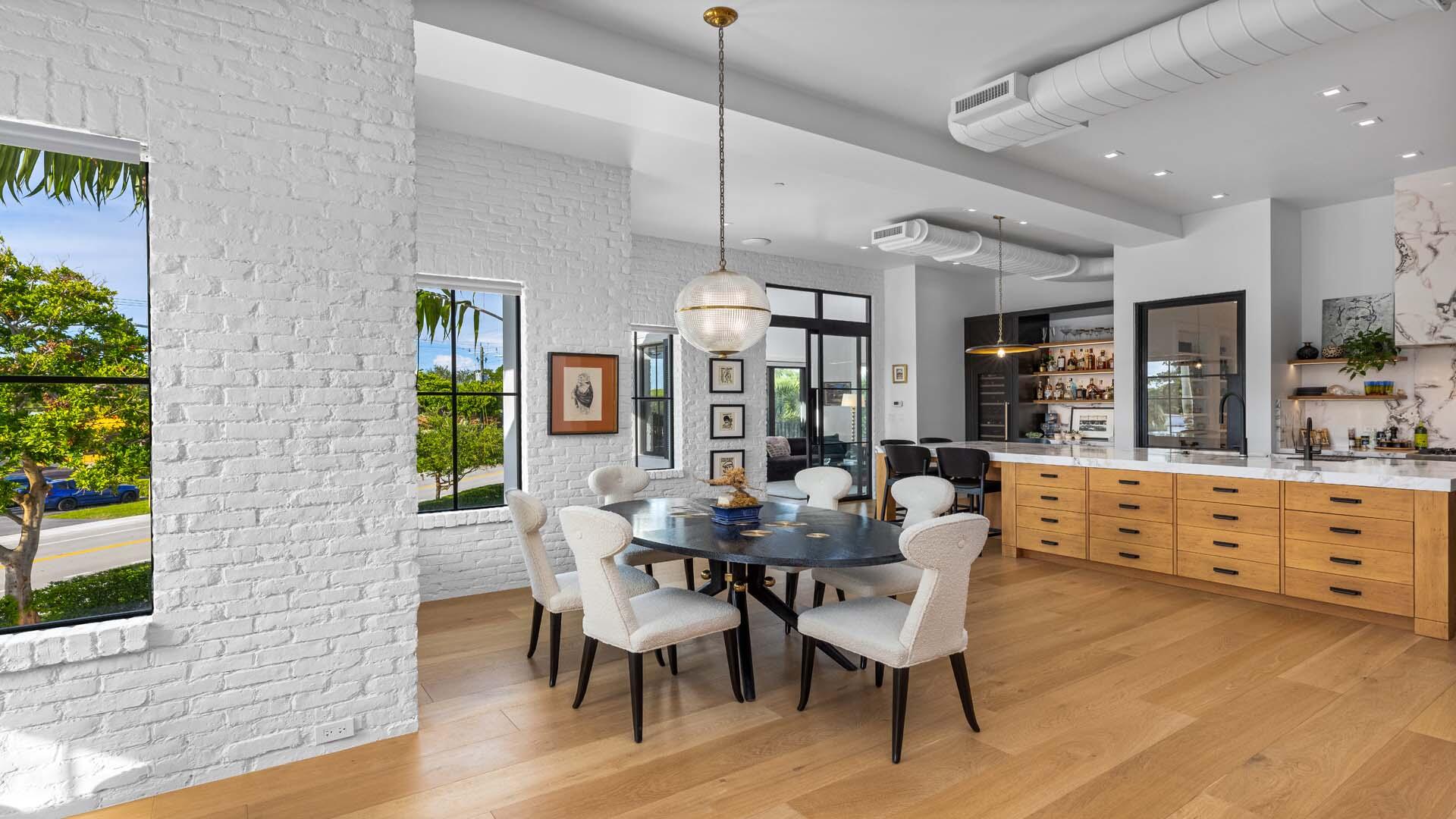 230 George Bush Boulevard Delray Beach, FL 33444 - Photo 12 of 51 a dining room with furniture a chandelier and wooden floor