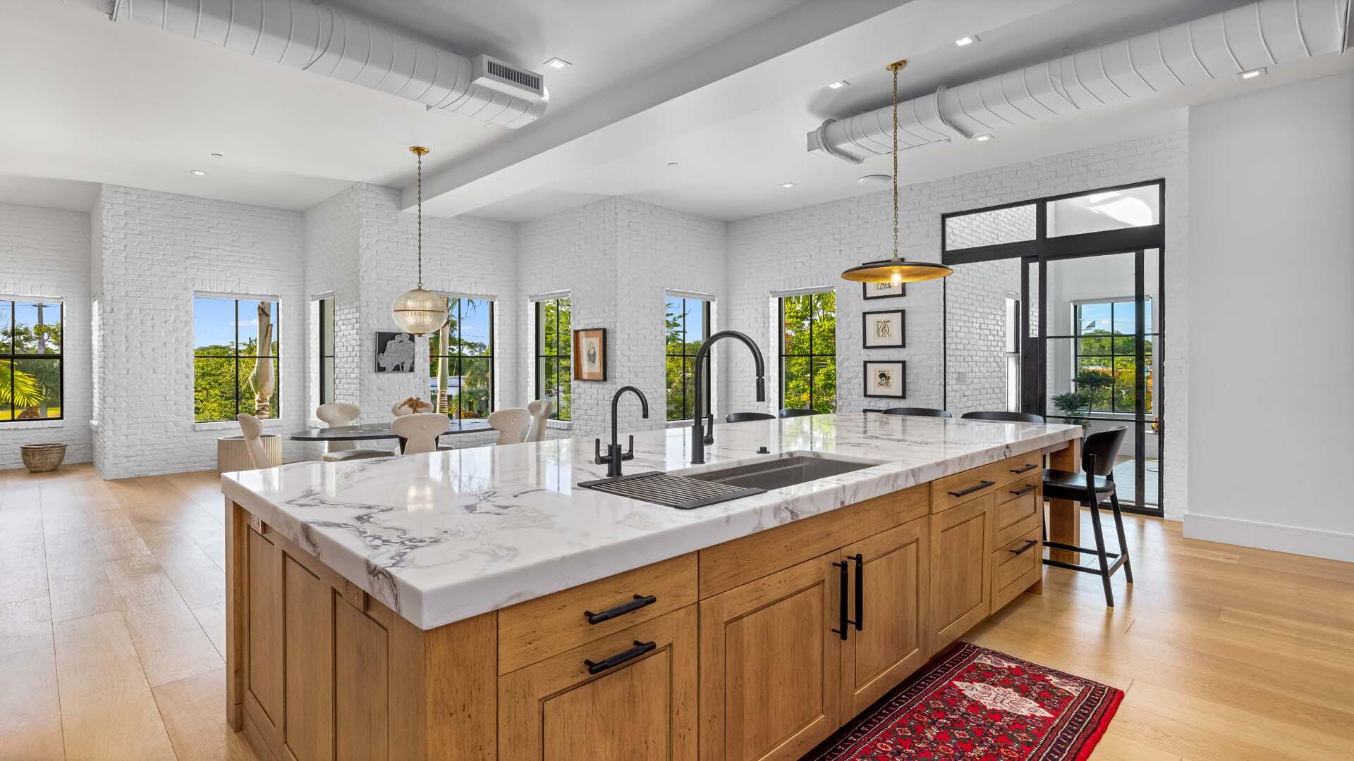 230 George Bush Boulevard Delray Beach, FL 33444 - Photo 16 of 51 a kitchen with center island table and chairs