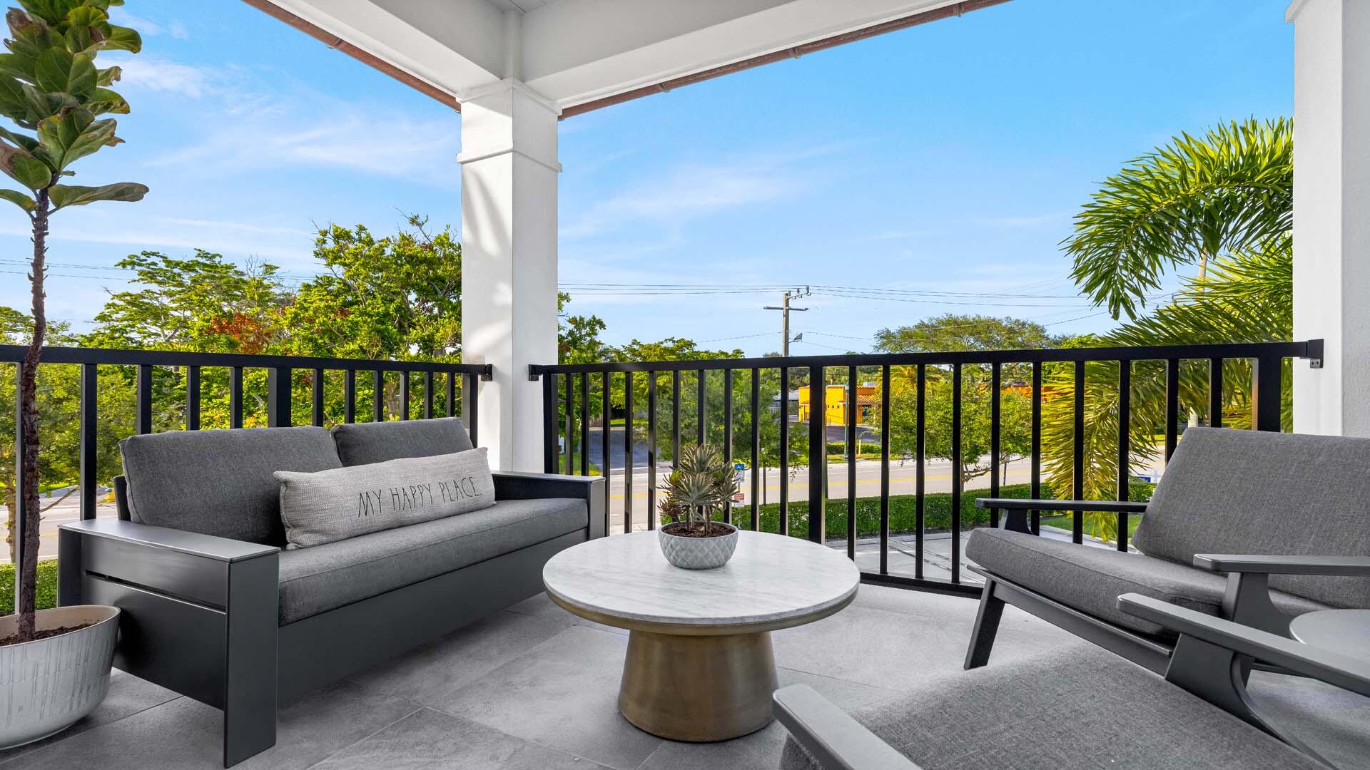 230 George Bush Boulevard Delray Beach, FL 33444 - Photo 22 of 51 a balcony with furniture and a potted plant