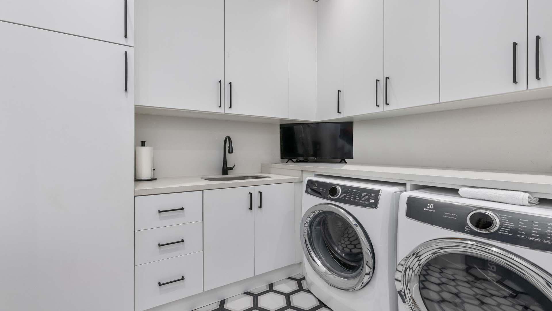 230 George Bush Boulevard Delray Beach, FL 33444 - Photo 32 of 51 a utility room with sink dryer and washer