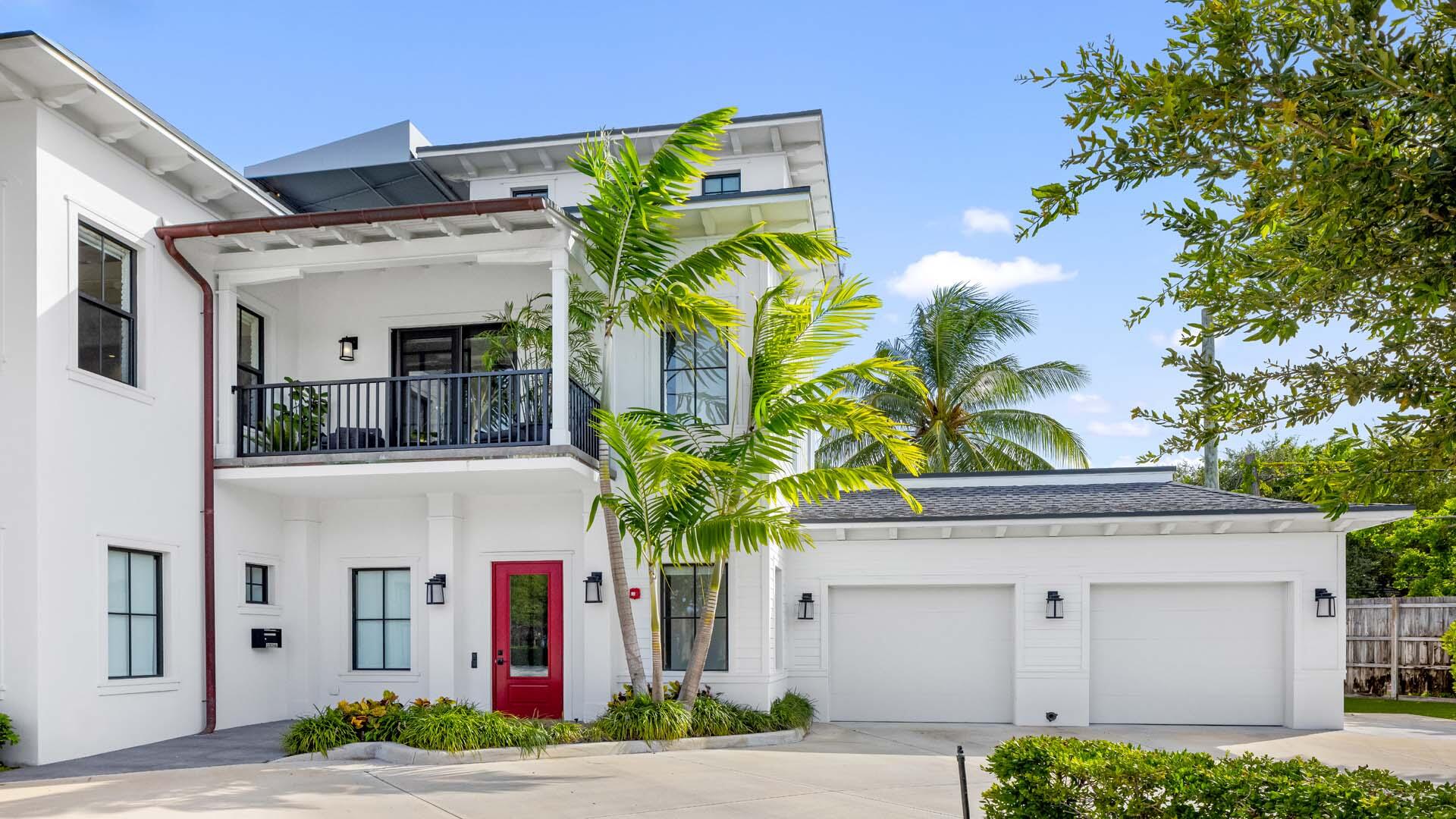 230 George Bush Boulevard Delray Beach, FL 33444 - Photo 4 of 51 a front view of a house with lots of yellow lighting