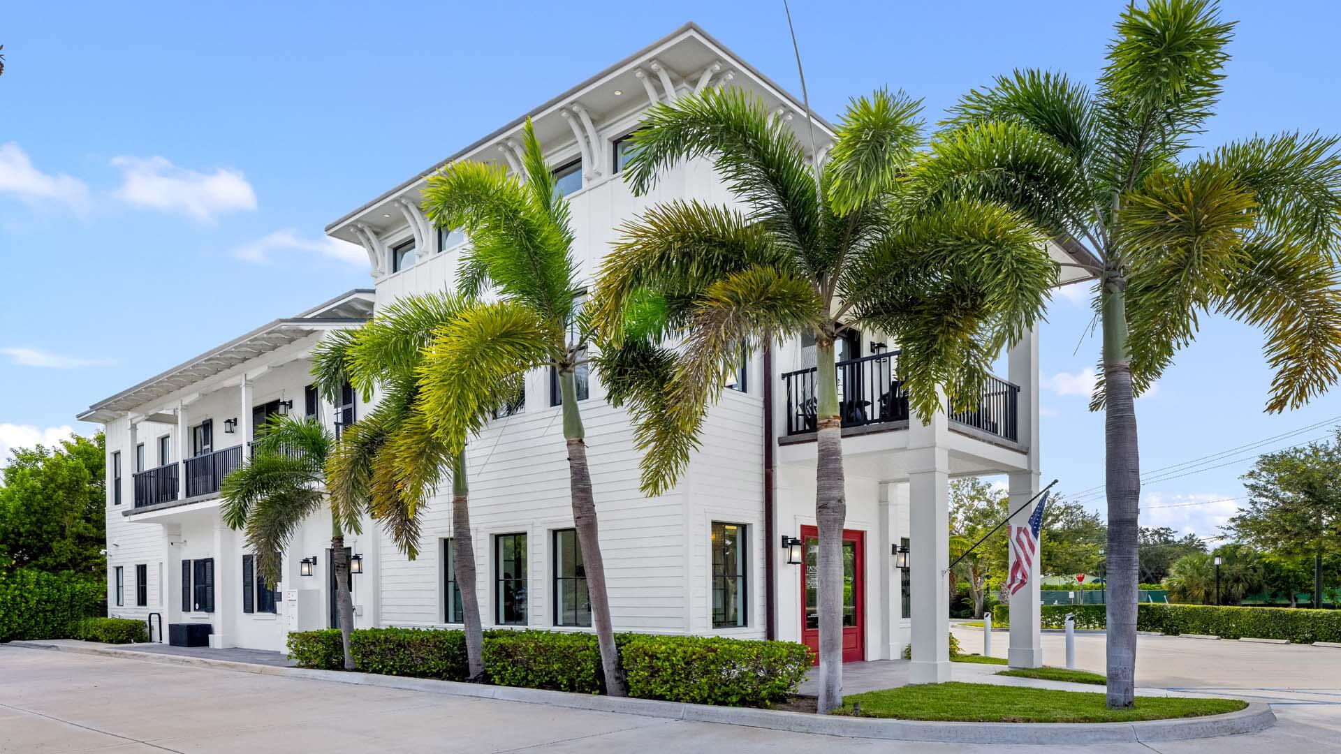 230 George Bush Boulevard Delray Beach, FL 33444 - Photo 45 of 51 a front view of multi story residential apartment building with yard and sign board