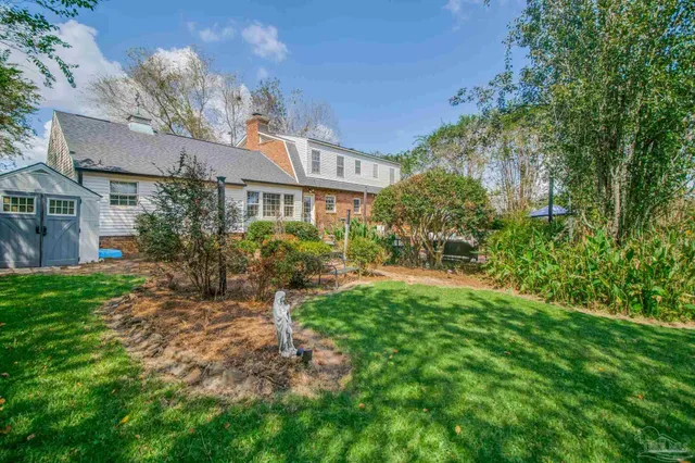 a front view of a building with a yard