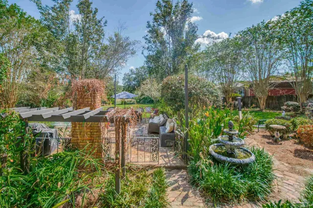 a view of a backyard with furniture and a fire pit